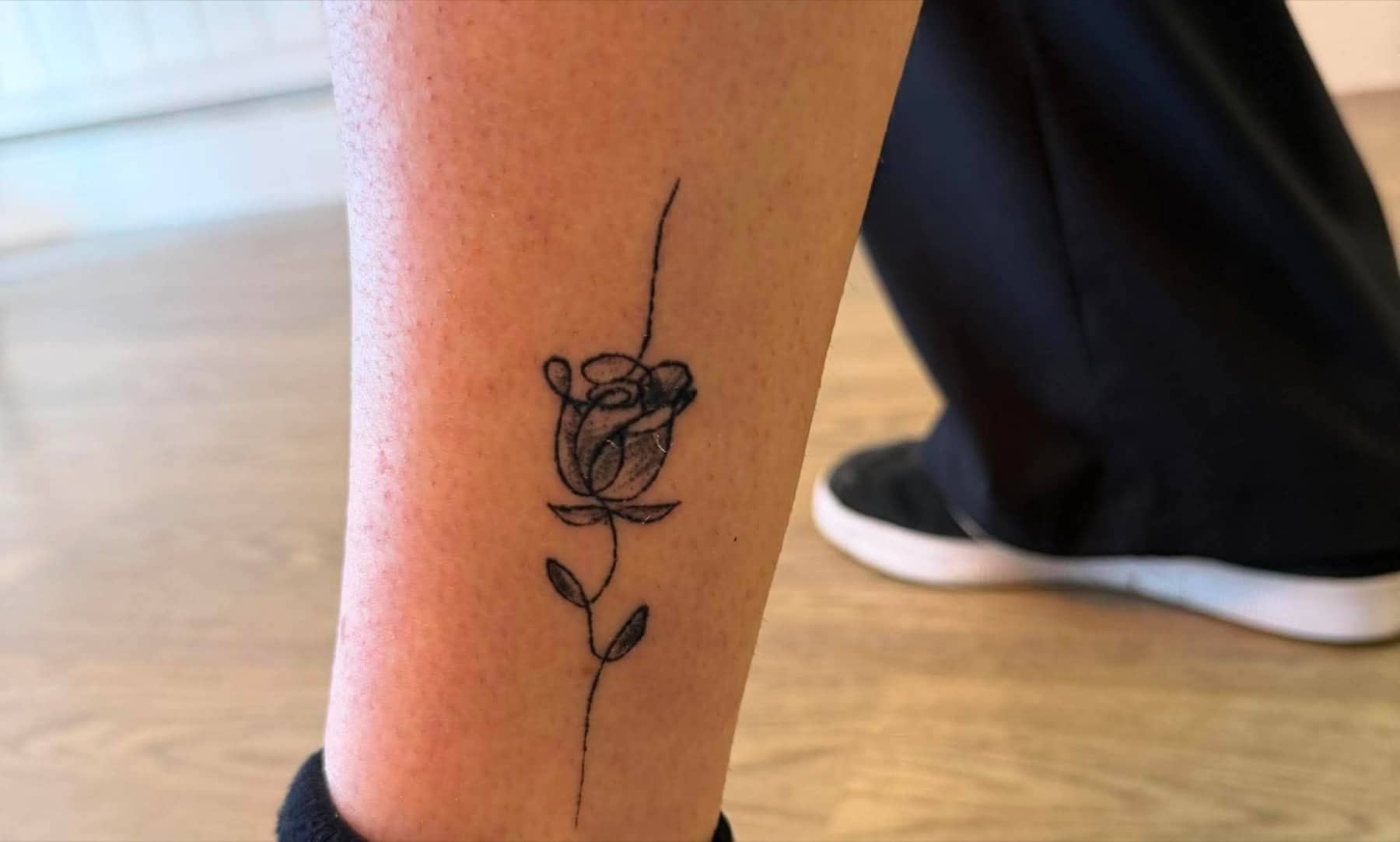 Fine line rose tattoo by Imogen Nia